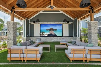 A wooden outdoor theater with a screen and seating.